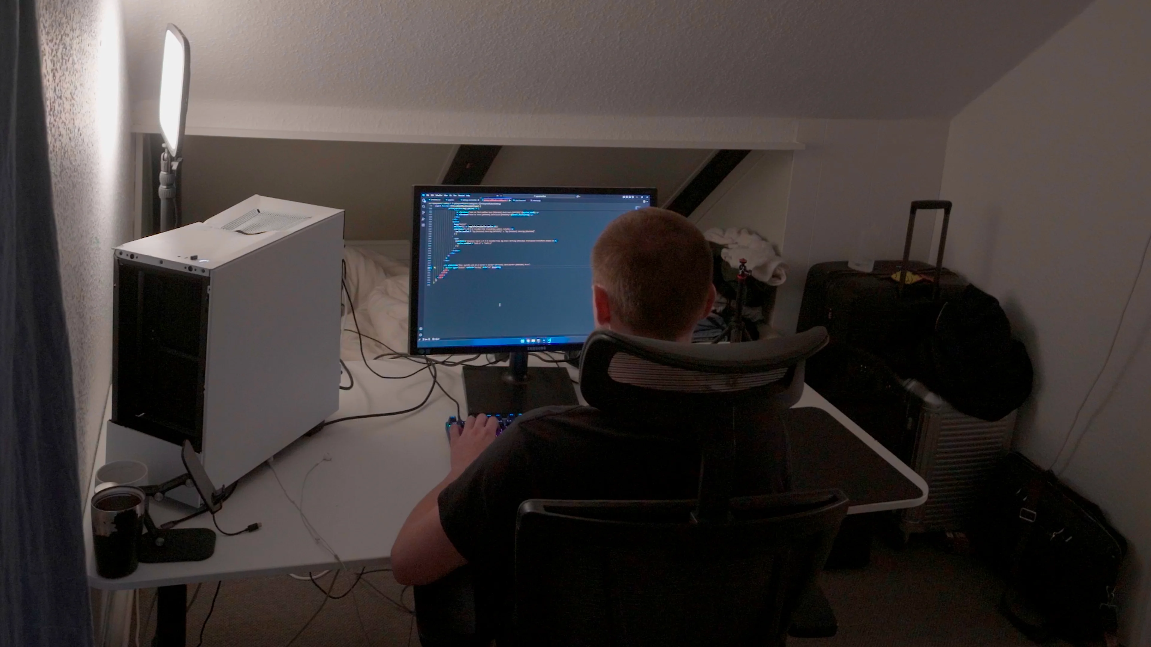 Kim Enrum coding and developing software at workspace in Denmark